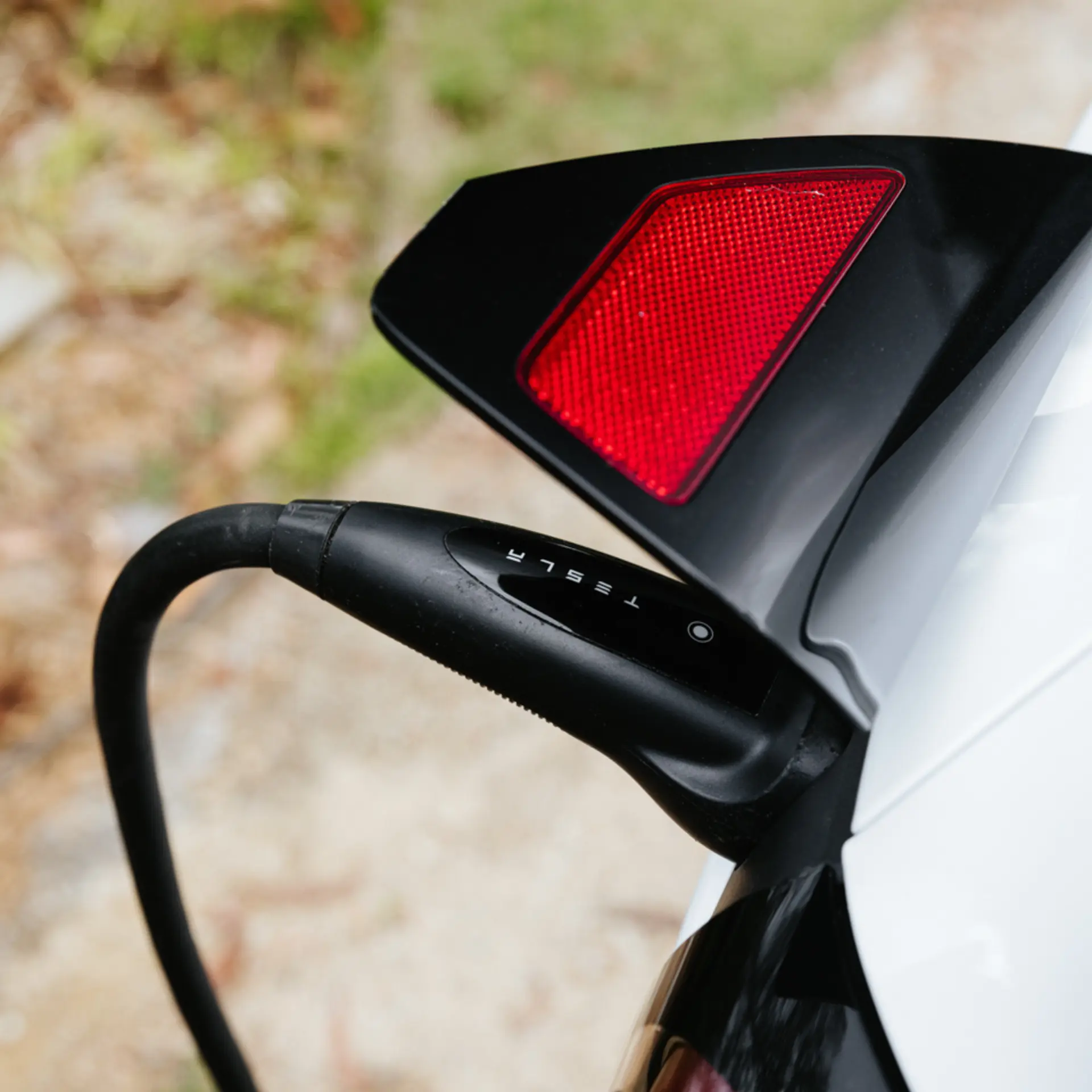 Tesla charger chord plugged into a Tesla electric vehicle